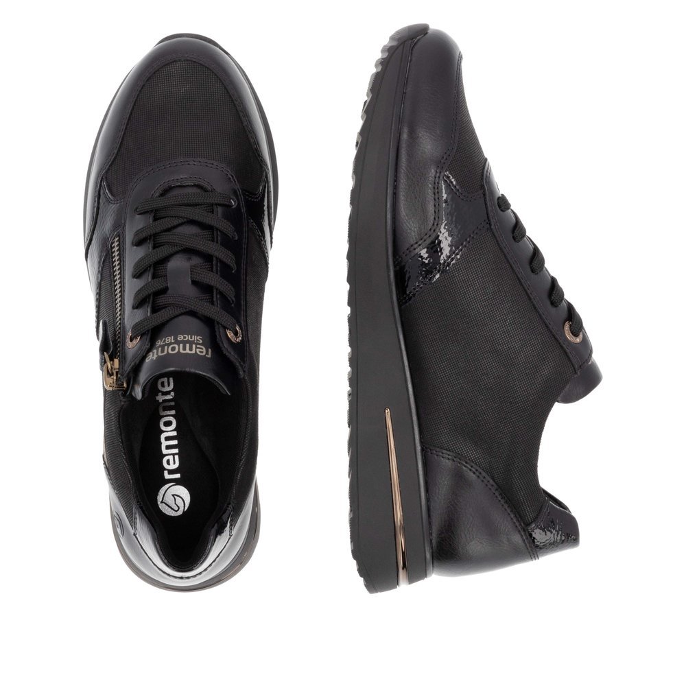 Black vegan remonte women´s sneakers D1G08-03 with zipper as well as padded insole. Shoe from the top, lying.