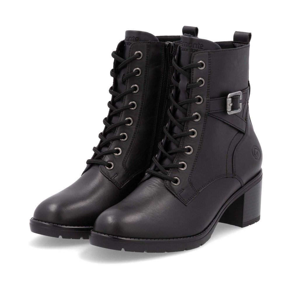 Black remonte women´s ankle boots D2A74-00 with decorative buckle as well as zipper. Shoes laterally.