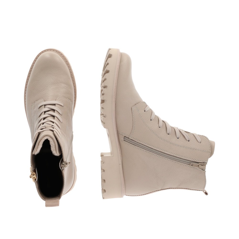 White beige remonte women´s lace-up boots D8671-60 with a distinctive eyelets. Shoe from the top, lying.