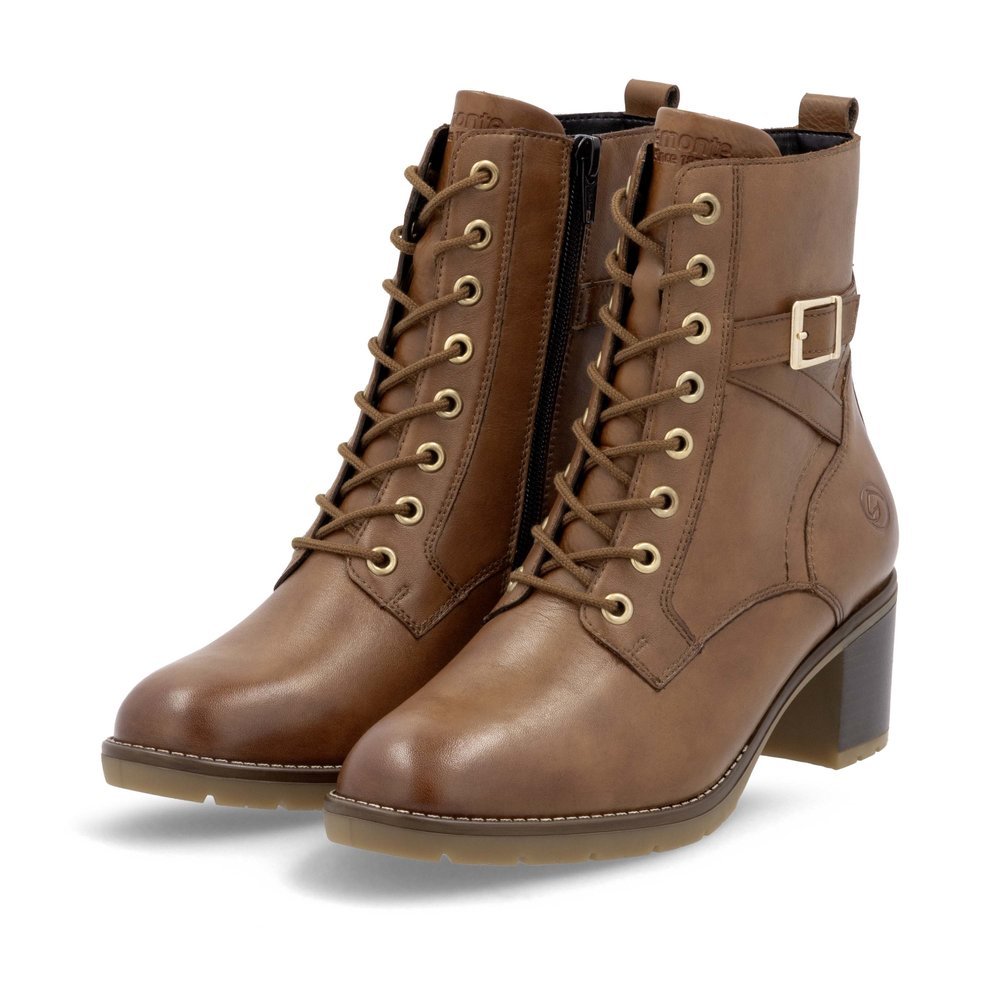 Brown remonte women´s ankle boots D2A74-24 with decorative buckle as well as zipper. Shoes laterally.