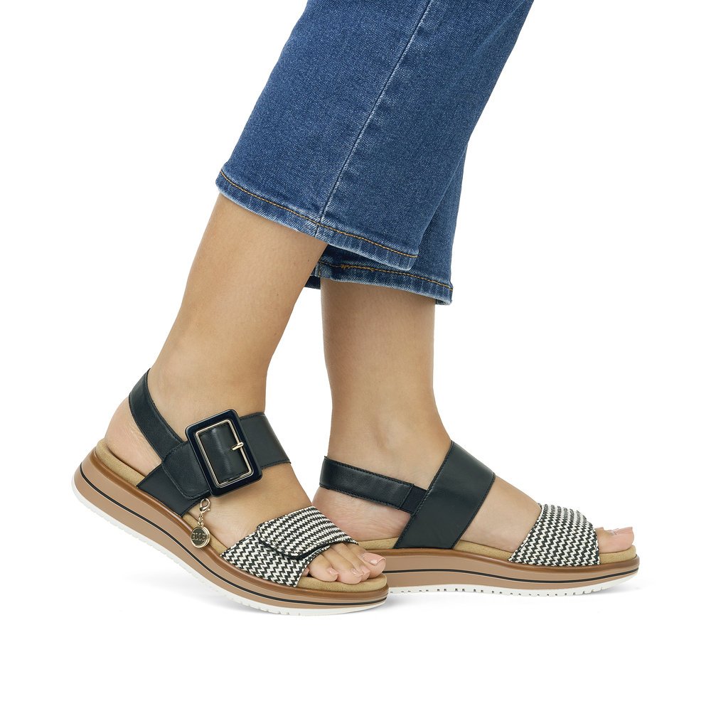Black remonte women´s strap sandals D1J53-02 with a hook and loop fastener. Shoe on foot.