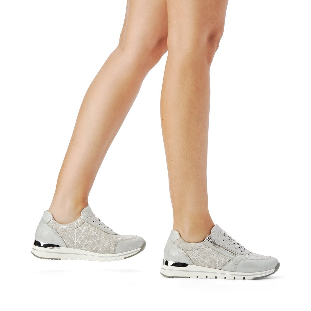 Grey remonte women´s sneakers R6700-40 with zipper and abstract pattern. Shoe on foot.
