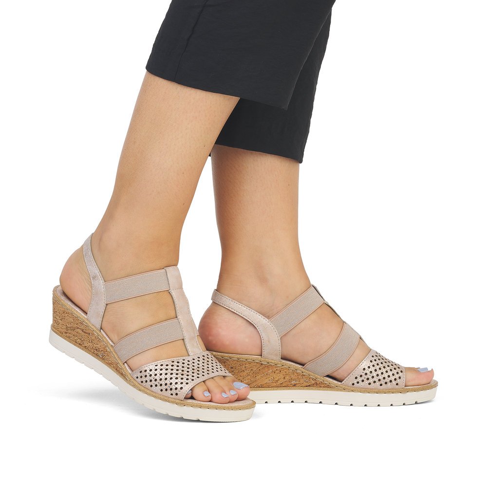 Pink remonte women´s wedge sandals R6265-31 with elastic insert and perforated look. Shoe on foot.