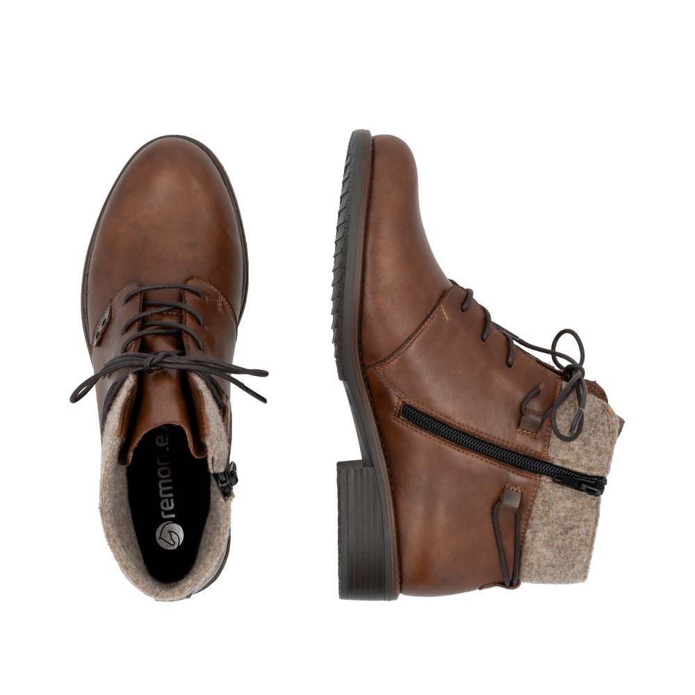 Brown remonte women´s ankle boots D0F78-22 with a shaft collar as well as a zipper. Shoe from the top, lying.