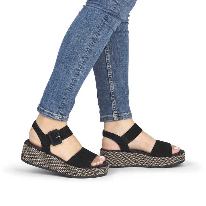 Schwarze remonte Keilsandaletten D1N54-01 mit einem Klettverschluss. Schuh am Fuß.