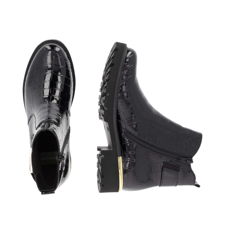 Vegane, schwarze remonte Chelsea Boots D8684-03 mit goldenen Details. Schuh von oben, liegend.